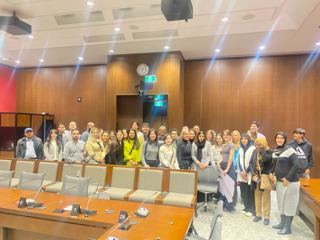 A large group gathered in a meeting room.