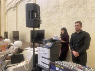 Presenters speaking at a lectern.