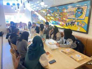 Community members exchanging ideas around a table.