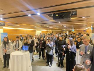 A room filled with guests listening at a GLOCAL gathering.
