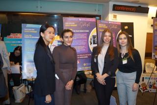 Participants beside youth project posters.
